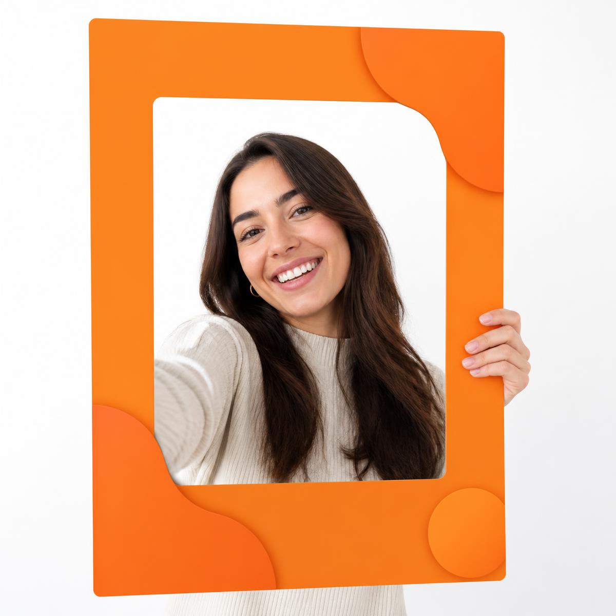 Attendee holding a branded orange event photo frame with her selfie inside